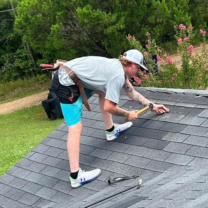 Lee Roofing technician replacing damaged shingles